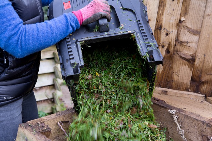 Emptying a lawn clippings bag. Sarah Cuttle Emptying a lawn clippings bag. Sarah Cuttle